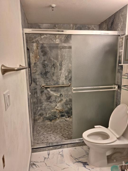 The same bathroom with its sliding shower door in
