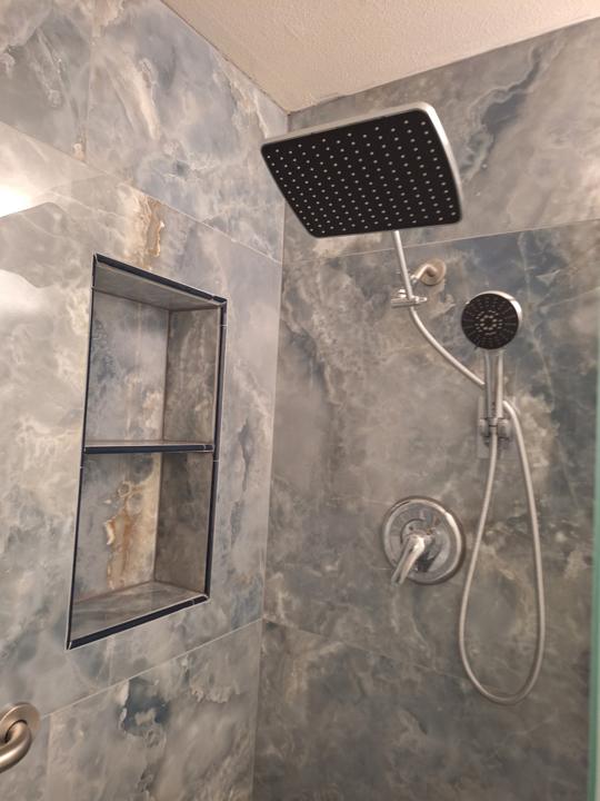 Recessed shower niche with rain head and hand shower