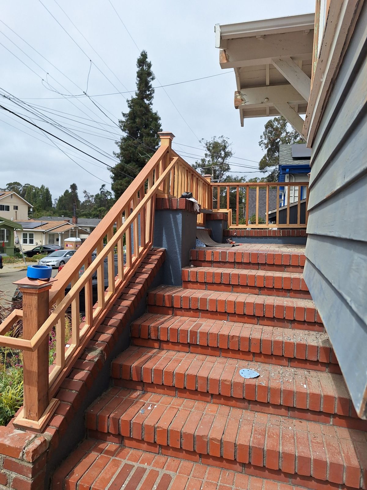 Brick front steps with a new wood railing