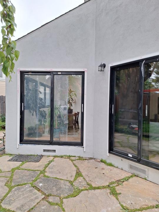 Sliding glass doors set into a stucco wall